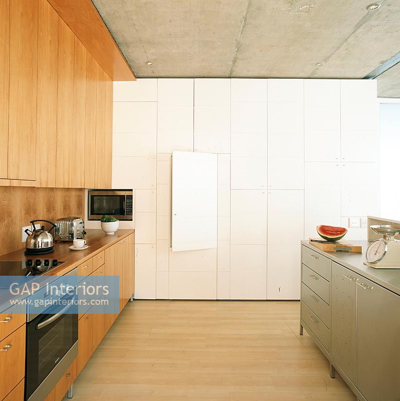 Modern kitchen with a wall of hidden cabinets