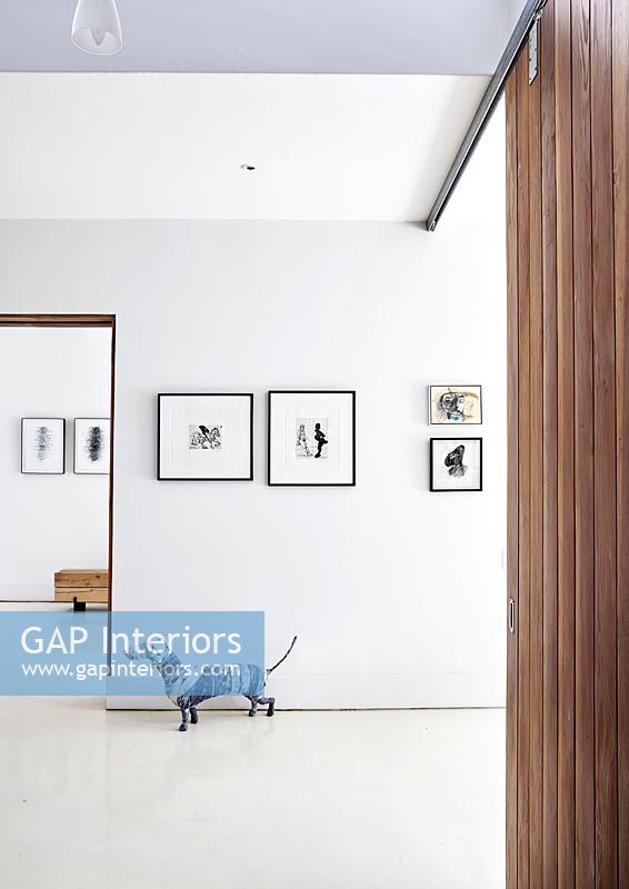 Contemporary hallway with display of artwork 