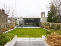 View across garden to contemporary house exterior 