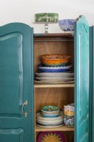Detail of open cabinet with crockery collection