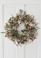 Detail of rustic Christmas wreath on white door