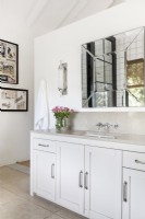 Mirror above vanity in neutral bathroom