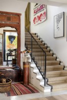 Staircase beside antique mirror and artwork