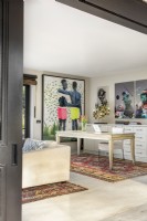 Home office with colourful art and rugs