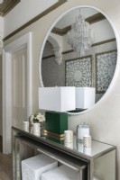 Chandelier reflected in mirror in modern hallway