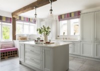 Colourful blinds in white country kitchen with large island