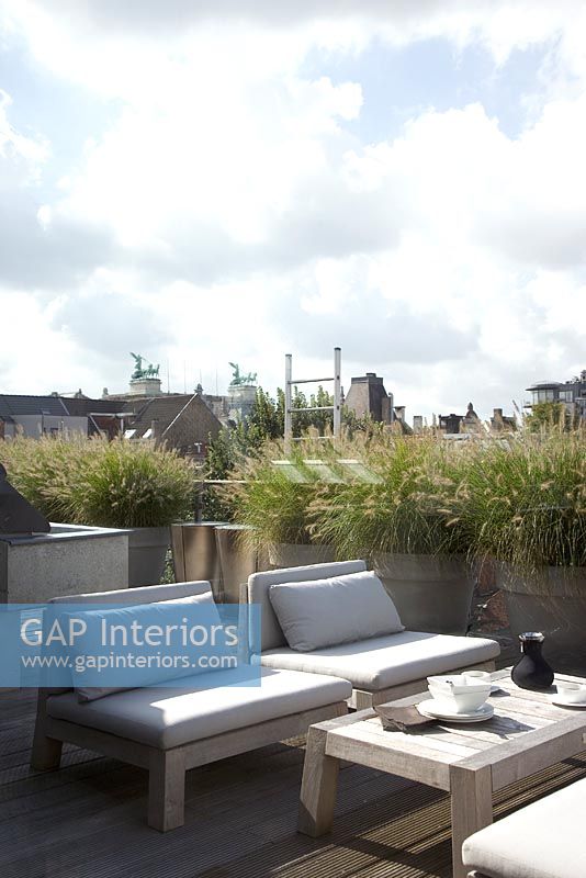Chairs and table on urban roof terrace 