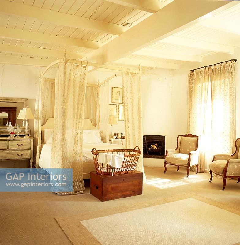 Spacious bedroom with a four poster canopy bed