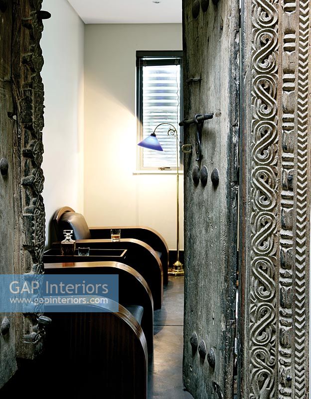 Ornately carved doors to modern living room