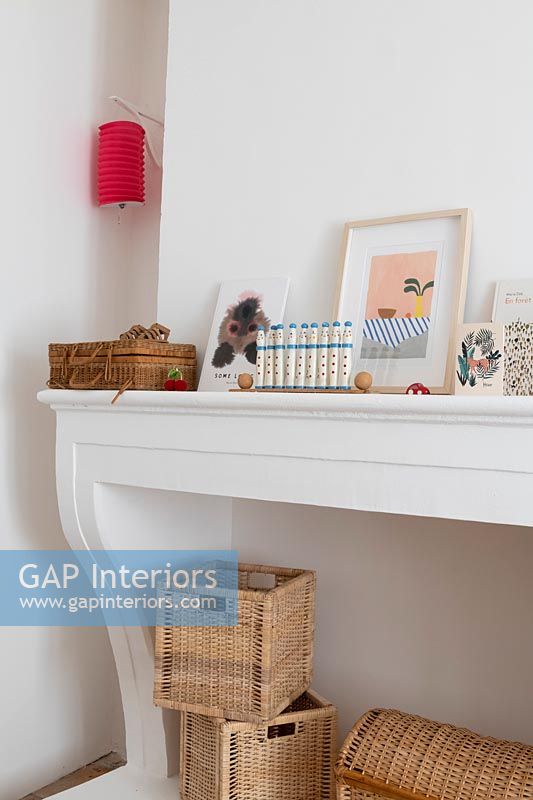 Mantelpiece with pictures and toys in childrens room 