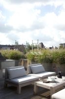 Chairs and table on urban roof terrace 