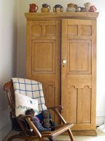 Wooden wardrobe and chair in bedroom 