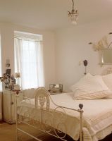 Classic bedroom with white iron bedstead