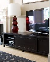Television and lamp on sideboard