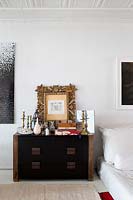 Accessories on black chest of drawers