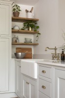Butler sink and shelves in shaker style blue and grey kitchen 