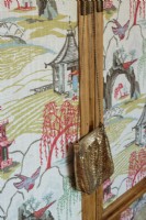 The Chinese bamboo armoire is covered with an Oriental print.
