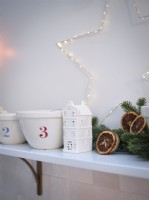 Christmas ornaments and star light display with dried orange garland