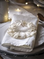 Decorative place setting napkin detail with dried floral wreath