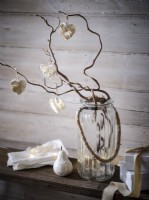 Bare branch vase detail with decorative hanging dried flower hearts